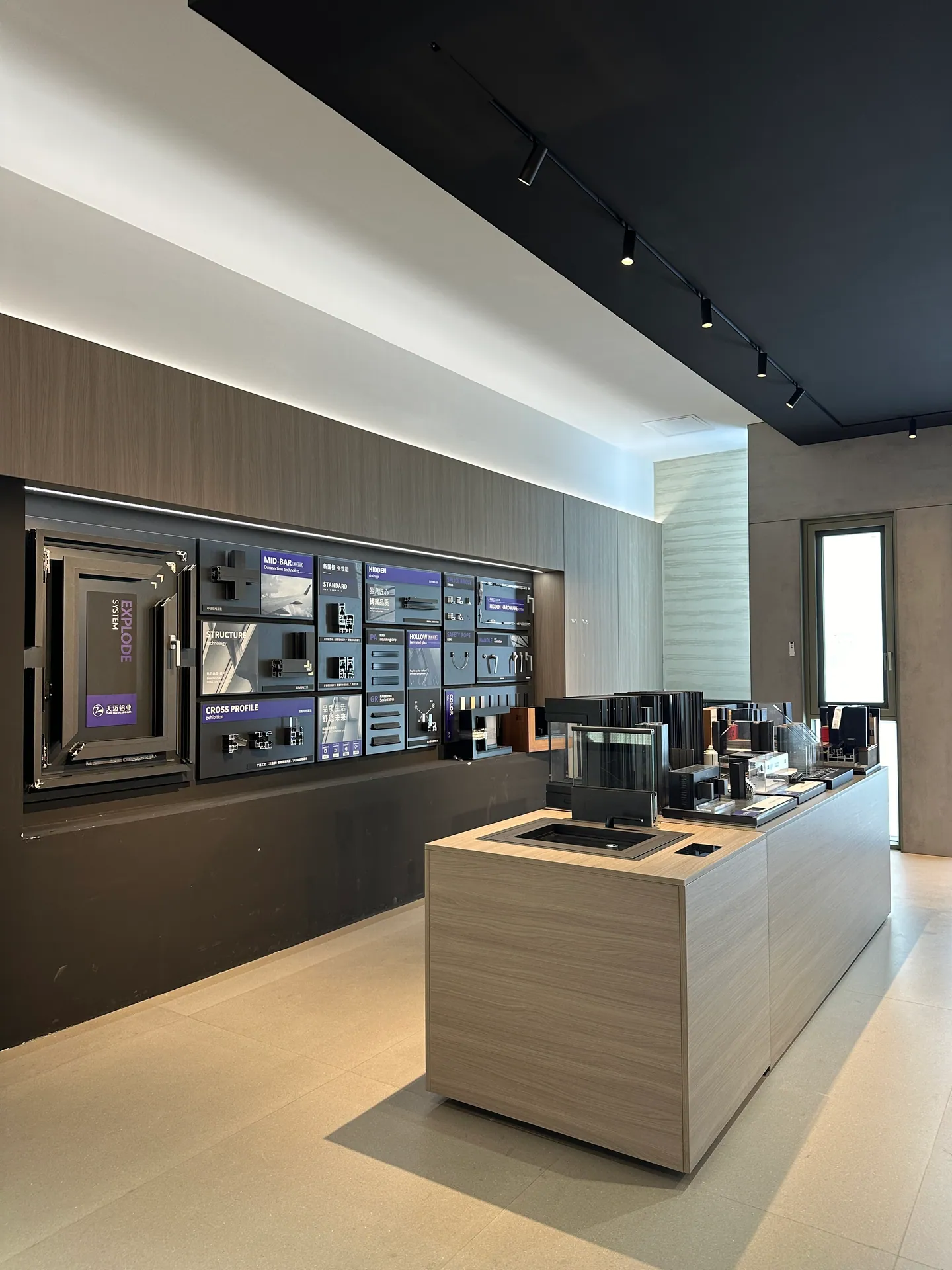 Architectural hardware and door-system samples compared in a Foshan supplier showroom