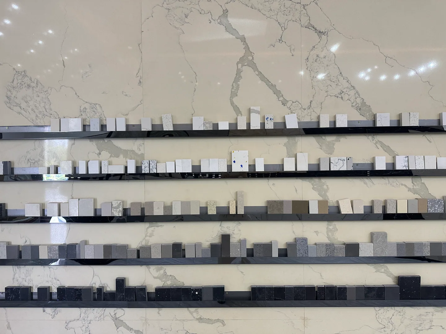 Stone and engineered-surface samples arranged for batch and finish comparison